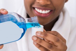 rinsing the mouth with mouthwash